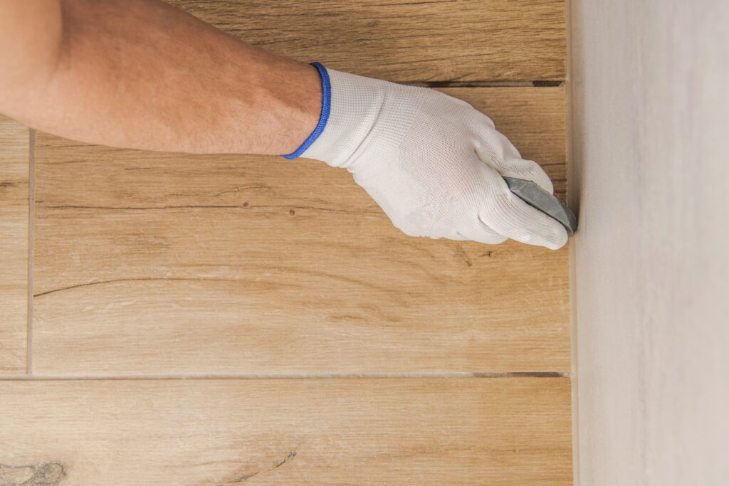 LiVE Services Group plumber removing plumbers putty after a bathroom installation